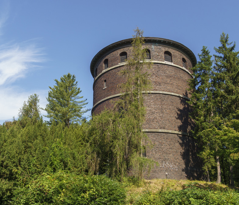 The brick Volunteer Park Water Tower rising above evergreen trees